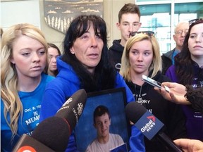 Kim Thomas holding photo of son Brandon Thomas, 17, who was killed by drunk driver Ryan Gibson in head-on crash on Highway 22 south of Cochrane on Dec. 6, 2012, is collecting shoes as a representation of the number of people who die from impaired-related crashes every year. She plans to use the shoes an awareness event at the Calgary courts.