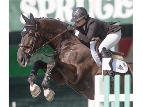 Tiffany Foster riding Tripple X III during the $33,500 ATCO Energy Solutions Cup at the Spruce Meadows North American tournament in Calgary on Wednesday July 2, 2014. (Jenn