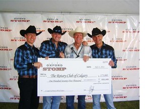 A total of $175,000 was raised at Oxford Stomp. The cheque was presented by Oxford Properties vice-president David Routledge, left, president and CEO Blair Hutcheson and EVP Michael Kitt, right, to Joe Fras of the Rotary Club of Calgary, second from right.