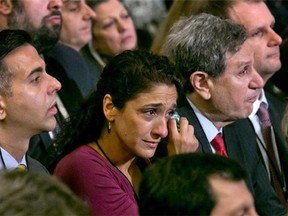 A woman in the audience dries a tear during the dedication ceremony in Foundation Hall, of the National September 11 Memorial Museum, in New York, Thursday, May 15, 2014. (AP Photo/Richard Drew, Pool)