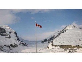 The Canadian flag flies over the Athabasca Glacier part of the Columbia Icefields in Jasper National Park, on May 7, 2014.