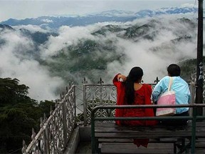 A tourist couple enjoy the view in the northern Indian city of Shimla.