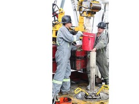 Trinidad Drilling floor hands Ron Ernst and Tobias Metz, at a Legacy Oil + Gas rig near Turner Valley.