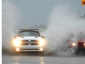 A truck blasts through a puddle at Broad and College during an afternoon downpour in Regina, Sask. on Sunday June 29, 2014. (Michael Bell/Regina Leader-Post)