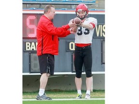 University of Calgary kicker Johnny Mark works with kicking coach Jim Hartley in a 2012 training camp photo. Mark went to the Stampeders’ hated rivals, the Saskatchewan Roughriders in Tuesday’s CFL draft.