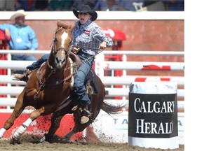 Utah barrel racer Nancy Hunter steers her horse Fuzz around the course for the fastest time of 17.53 seconds during the Calgary Stampede rodeo on Wednesday.