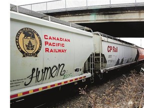 A vandalized car can be seen on a Canadian Pacific Railway train passing through Calgary. Reader says it's vandalism, not art.