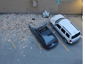 Vehicles were damaged by more bricks falling off the wall of a building at 6 Avenue and 7 street S.W. on Sunday.
