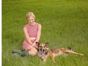 Veterinarian Sarah Boston, seen here relaxing with Rumble, wrote the book Lucky Dog about her experience as a cancer patient.