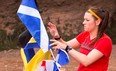Natalie rearranges nautical flags during a challenge on the Bay of Fundy on this week's episode of The Amazing Race Canada.
