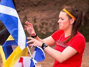 Natalie rearranges nautical flags during a challenge on the Bay of Fundy on this week's episode of The Amazing Race Canada.