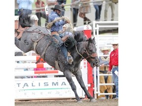 Wade Sundell rides to a 88.00 during Day 7 of the Calgary Stampede saddle bronc Championship on Thursday.