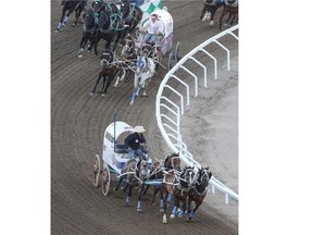 Wayne Knight checks on his lead during Heat 5 on Night 6 of the Rangeland Derby at Stampede Park in Calgary on Wednesday. His team was so fast he took a late outrider penalty and had to settle for the day’s third-best time.