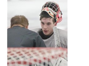 Zach Sawchenko talks with a coach between drills during practice at Hockey Canada’s annual goalie development camp in Calgary on Friday. The Calgarian is one of 34 netminders camping out at Canada Olympic Park’s Markin MacPhail Centre this week.