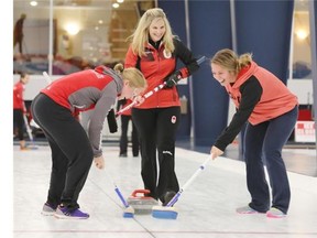 2014 Olympic gold medal curler Jennifer Jones laughs with bobsledders Kate O’Brien, left and Julia Corrente during a team building exercise at the Glencoe Club on Thursday. Jones is in town for the World Curling Tour’s Autumn Gold Classic at the Calgary Curling Club, starting Friday, while the bobsledders are training at Canada Olympic Park this weekend.