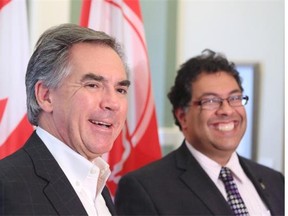 Alberta Premier-designate Jim Prentice and Calgary Mayor Naheed Nenshi share a laugh while speaking with the media after meeting at Calgary’s City Hall on Tuesday.