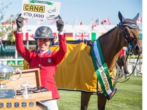 American Lauren Hough receives her $70,000 cheque after riding Ohlala to a first place finish with zero faults and a time of 59.901 at the Spruce Meadows Cana Cup on Thursday.