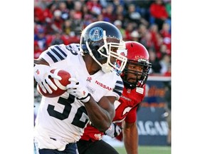 Argonauts slotback Andre Durie, here getting chased down by Stampeders linebacker Deron Mayo at McMahon Stadium last season, returns from a broken clavicle for Saturday’s game in Calgary.