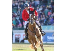 Ben Asselin and his horse, Makavoy, celebrate after a double clear and a Team Canada victory at the BMO Nations' Cup at Spruce Meadows in Calgary on Saturday, Sept. 13, 2014.