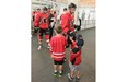 Benett Miller, 8 and his brother Nolan, 4 get some high five’s from players at the Calgary Flames 2014 training camp at the WinSport arenas on Friday.