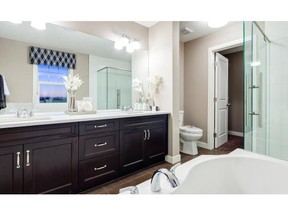 Beyond the master bedroom is a tile-floored ensuite with a quartz-topped vanity that holds two sinks and lots of cabinet space. Marty Hope, for the Calgary Herald.