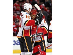 Brian McGrattan, left, hugs goalie Jonas Hiller after Calgary’s 2-1 overtime victory.