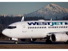 A pilot taxis a Westjet Boeing 737-700 plane to a gate after arriving at Vancouver International Airport in on February 3, 2014. THE CANADIAN PRESS/Darryl Dyck