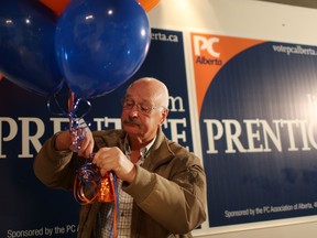 Gary Vegelis hangs balloons at the Jim Prentice byelection party Leah Hennel/Herald