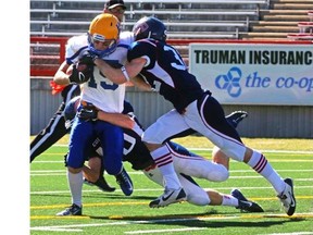 Calgary Colts defender Jordan Fasano tackles Saskatoon Hilltops Des Vessey during the PFC action earlier this season at McMahon Stadium. The Colts are in Regina for a playoff matchup Saturday against the Thunder.