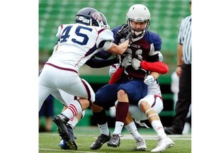 Calgary Colts defenders  tackle Regina Thunder wide-receiver Preston Bews during their game in Regina on Sunday. The Colts won 20-13 for their second win of the season.