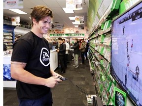 Calgary Flames centre Sean Monahan tries his hand at the new EA Sports NHL 15 game while meeting fans at EB Games in Mackenzie Towne on Tuesday.