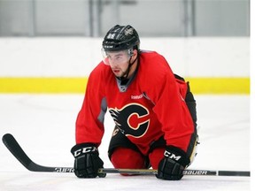 Calgary Flames forward Josh Jooris streches out during practice on Monday. The rookie hopes to suit up against the Tampa Bay Lightning on Tuesday.
