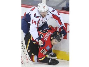 Calgary Flames forward Josh Jooris takes a hit from Washington Capitals defenceman Brooks Orpik on Saturday night.