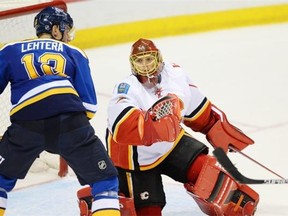 Calgary Flames’ goalie Jonas Hiller blocks a shot by St. Louis Blues’ Jori Lehtera during their Saturday meeting. The Flames lost 4-1, but the setback can hardly be blamed on Hiller. Calgary plans to keep rotating goalies (between Hiller and Karri Ramo) until one develops a hot hand.