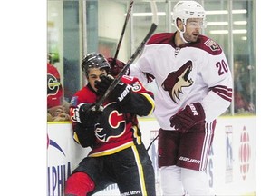 Calgary Flames left winger Johnny Gaudreau was driven into the boards by Arizona Coyotes defenceman Chris Summers during the Kraft Hockeyville game last Wednesday in Sylvan Lake. Reader Jim Heynen writes that violence is wrong on and off the ice.