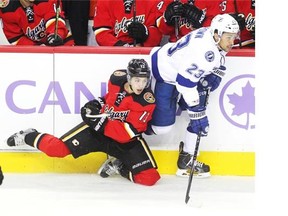 Calgary Flames left winger Johnny Gaudreau stumbled along the boards while skating against Tampa Bay Lightning right winger J.T. Brown during the first period on Tuesday night.