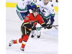 Calgary Flames rookie Johnny Gaudreau looks for an opening against the Vancouver Canucks during their home opener on Wednesday night at the Scotiabank Saddledome.
