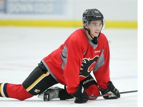 Calgary Flames rookie Johnny Gaudreau stretches during practice on Monday. What does he have in store now that he’s broken the goose-egg in points on the season?