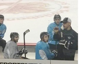 Calgary Hitmen head coach Mark French sketches out a diagram for his players during practice on Thursday. The Hitmen will host the Red Deer Rebels in their home opener on Saturday night.