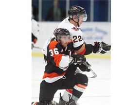 Calgary Hitmen player Linden Penner, top, battles against Medicine Hat Tigers player Trevor Cox during a preseason game at the Bob Snodgrass Rec Complex in High River last weekend. The Hitmen are projected to be one of the WHL’s top teams this season.