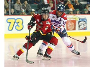 Calgary’s Rebecca Johnston keeps the puck away from Montreal’s Caroline Ouellete in Canadian Women’s Hockey League action at Scotiabank Saddledome on Sunday. Calgary won 3-2, taking two of three games from their rivals during a weekend series.