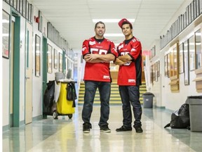 Calgary Stampeder Randy Chevrier, left and Anthony Parker, pose in the hallway at St. Mary’s high school where they helped launch Leading Change: The Alberta CFL Project, which raises awareness of violence and abuse against women.