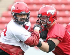 Calgary Stampeders defensive lineman Corey Mace, left, goes up against offensive counterpart Spencer Wilson during practice at McMahon Stadium on Tuesday. Mace is relieved to be healthy again after battling a turf toe injury that has kept him out of six games this season.