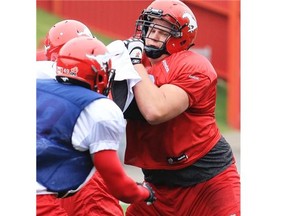 Calgary Stampeders offensive lineman Shane Bergman, right, runs drills during practice at McMahon Stadium on Wednesday. The Stamps would clinch first in the West Division at this early stage if they beat the Winnipeg Blue Bombers on Saturday.