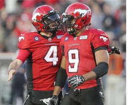 Calgary Stampeders quarterback Drew Tate, left, and Jon Cornish celebrate a touchdown during their comeback win over the Toronto Argonauts on Saturday.