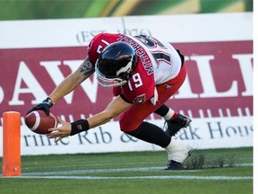 Calgary Stampeders quarterback Bo Levi Mitchell reaches for a second-quarter touchdown on Saturday night in Edmonton. The pivot broke the CFL record for the best start to his career, getting his 12th win in 13 starts.