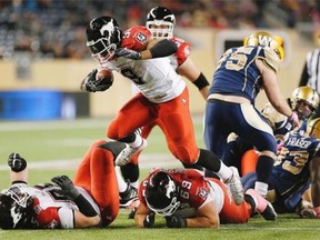 Calgary Stampeders running back Jon Cornish runs for yards against the Winnipeg Blue Bombers during the second half on Saturday. Cornish gashed the Bombers for 160 yards to move into second on the career Canadian rushing leaders list.
