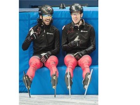 Canada’s Charles Hamelin, left, shares a laugh with teammate Michael Gilday during a break at the Sochi Olympics. Hamelin was, as expected, dominant at the short-track fall trials at the Olympic Oval.