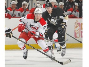 Chris Terry of the Carolina Hurricanes skates against then Pittsburgh Penguin James Neal during a game last April.