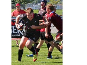 Clayton Panga of the Prairie Wolf Pack is tackled by Mike Hamson for the Atlantic Rock during Canadian Rugby Championship action last month.